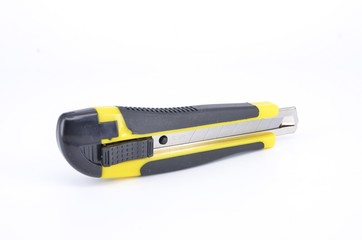 Yellow snap-off blade knife on white background.