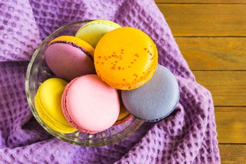 French pastries multicolored macaroon on a wooden background
