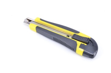 Yellow snap-off blade knife on white background.