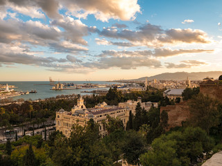 Fototapeta na wymiar Panorama view of the port of Malaga, Spain and the city hall building at sunset with an epic cloudy sky