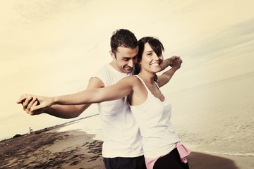 happy young couple have fun at beautiful beach