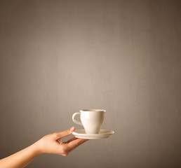 Female hand holding coffee cup