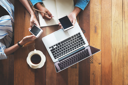 Directly Above Of Hipster Lifestyle And Creative Workspace In Cafe - Business Women Teamwork With Laptop, Mobile Phone In Coffee Shop. Startup Online Marketing, Top View - Vintage Effect Filter.