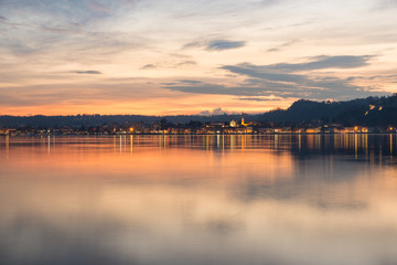 Fototapeta na wymiar Lake Maggiore, colorful sky at sunset, northern Italy. City of Arona, province of Novara, on the Piedmont side of Lake Maggiore, view from Angera