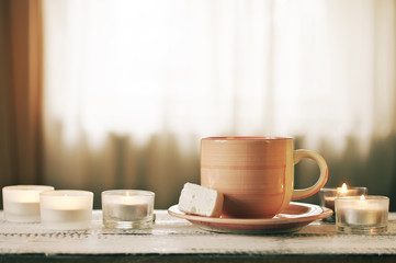 Cup of coffee and burning candles