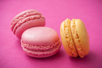 closeup of french macarons pastry on pink background