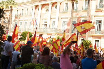 Spanish flags over the heads of protesters in the square