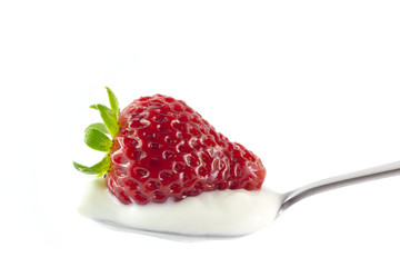 Spoon of yogurt with strawberry
