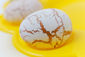beautiful painted Easter eggs in pastel tones with texture on the yellow plate