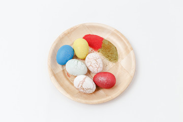 Easter eggs on a wooden plate