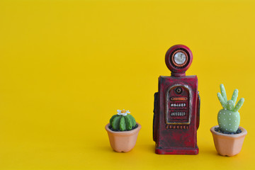 Vintage red gasoline pump with cactus abstract minimal yellow background, Car concept