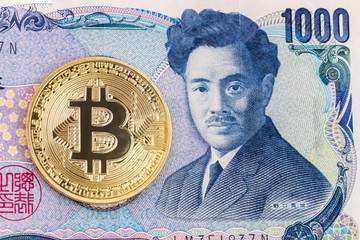 Close-up of a golden bitcoin on 1000 Yen banknote background