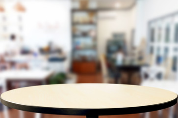 Selected focus empty brown wooden table and Coffee shop or restaurant blur background with bokeh image. for your photomontage or product display.