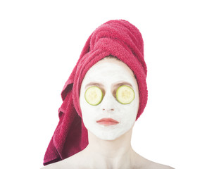 beautiful woman with beauty face mask on the face and cucumber