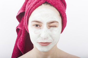 beautiful woman with face mask and creme winking