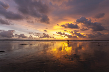 Fototapeta na wymiar Tropical sandy beautiful beach of Kuta in Bali at sunset. Indonesia