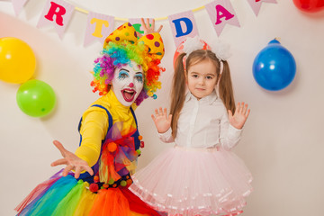 clown girl on the birthday of a child. A party for a child. shy Baby