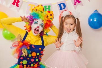 clown girl on the birthday of a child. A party for a child. shy Baby