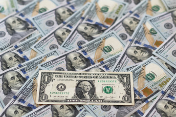 One american dollar on pile of hundred dollars. Concept finance, deposits.