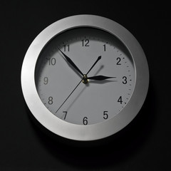 Wall clock, dial with arrows, soon three hours. 