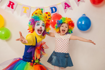 clown girl on the birthday of a child. A party for a child. A child in a clown wig