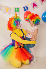 clown girl on the birthday of a child. A party for a child. A child in a clown wig
