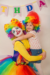 clown girl on the birthday of a child. A party for a child. A child in a clown wig