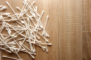 Cotton sticks on wooden background with copy space for your design
