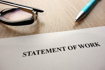 Statement of work, pen and glasses on desk
