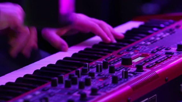 The musician playing the electric piano, Electric piano, Actor playing on the keyboard synthesizer piano keys. Musician plays a musical instrument on the concert stage. synthesizer