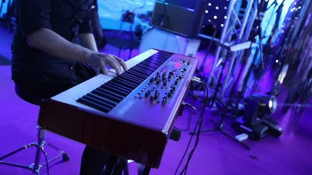 The musician playing the electric piano, Electric piano, Actor playing on the keyboard synthesizer piano keys. Musician plays a musical instrument on the concert stage. synthesizer