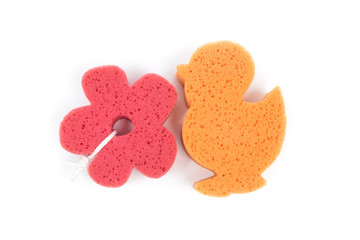 Flower and duck shaped bath sponge isolated on white background, surface. Red and orange bathing...