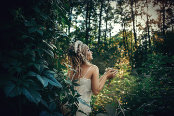 Beautiful model is posing in a forest with white horns 