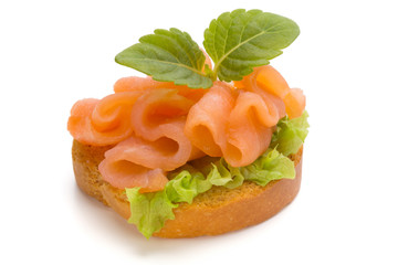 Bread with fresh salmon fillet isolated on white background, top view.