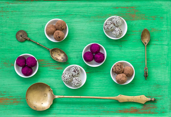 Bliss Balls coated in Beetroot Powder on Textured Green backdrop
