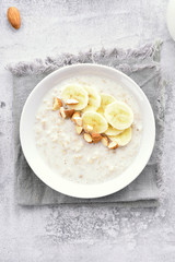 Oats porridge with banana slices and nuts