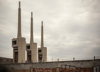 Three chimney of old thermal power plant,cloudy day, Sant Adria de Besos, province Barcelona,Catalonia.Spain.