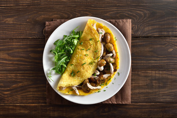 Omelet with mushrooms, chicken meat, greens