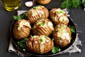 Baked potatoes with bacon, green onion and cheese