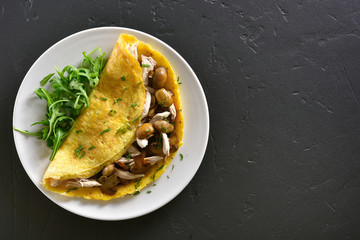 Omelet with mushrooms, chicken meat, greens