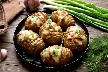 Baked potatoes with bacon, green onion and cheese