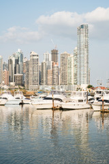 Obraz premium Vacations and Tourism Concept - modern yachts at harbor, Panama City skyline