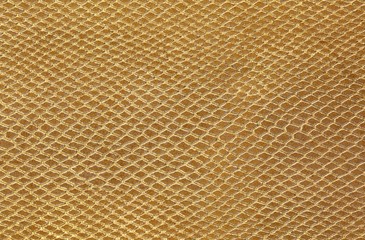 Golden background of scales similar to snakeskin