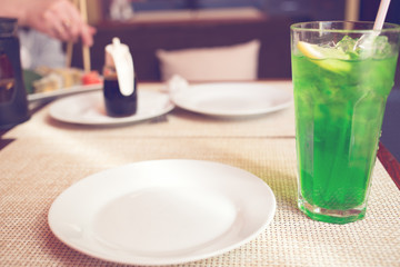 sweet herb drink emerald green color. Is made out of the water, lemon, sugar and the tarragon