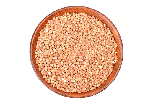 Buckwheat  in a wooden bowl  on a white background