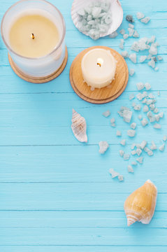 Spa concept with candles on blue wooden background