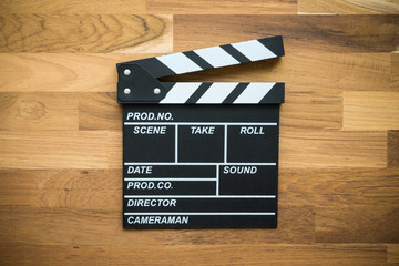 Cinema clapperboard on wooden background - Movie entertainment concept