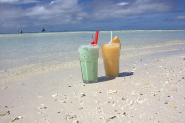 cocktail from a kiwi with milk and juice from a melon on the beach