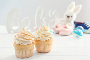 Tasty cupcakes for baby shower party on table
