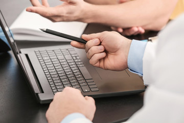 Doctor consulting male patient in clinic